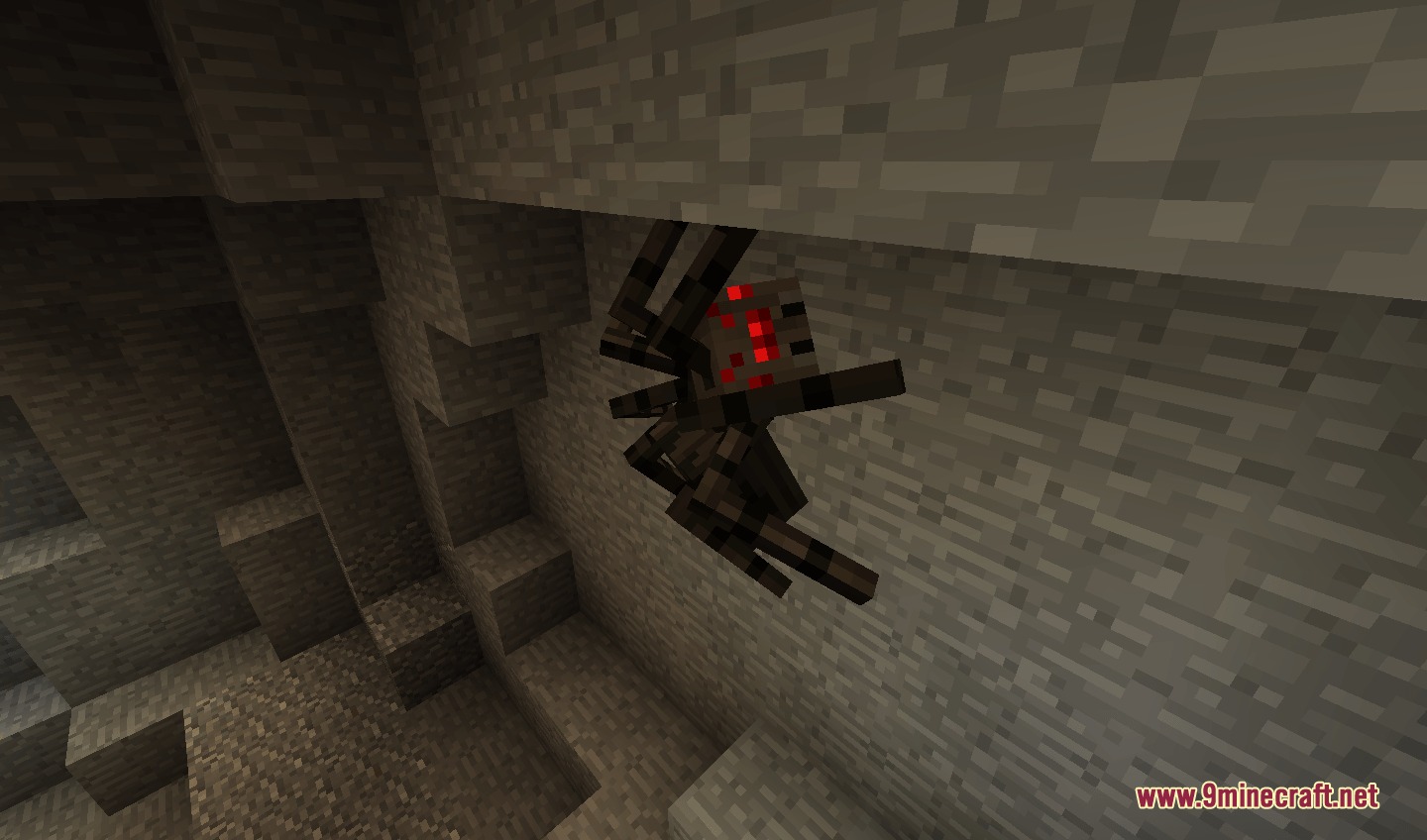 A spider with realistic leg poses crawls on a stone cave wall