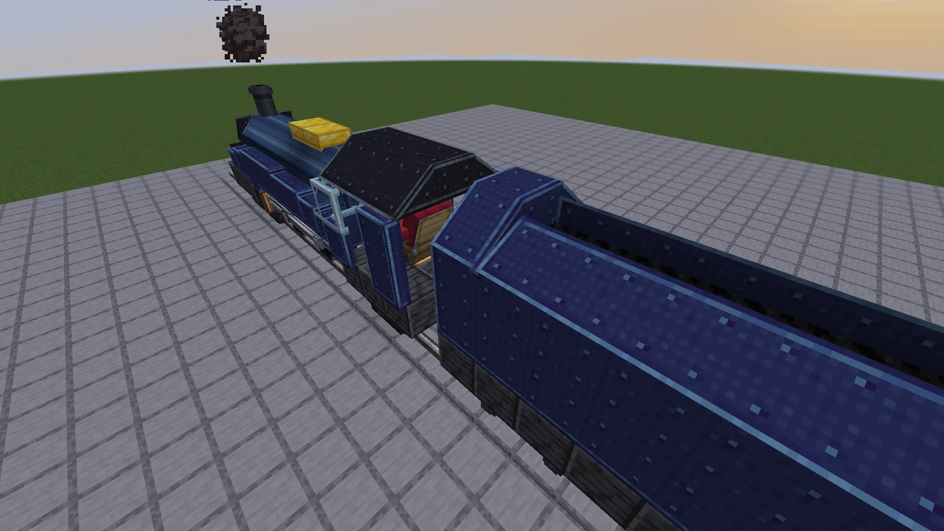 Side view of a blue steam locomotive and its attached coal tender