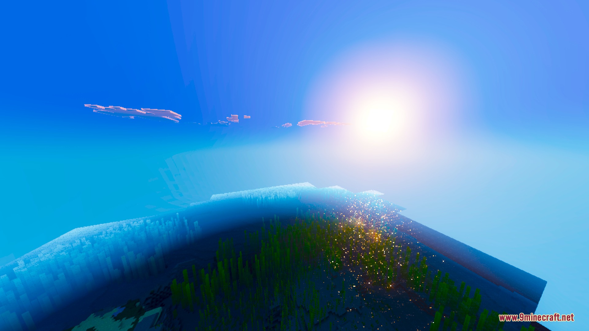 Bright sun with dramatic light shafts shining over a clear blue ocean surface