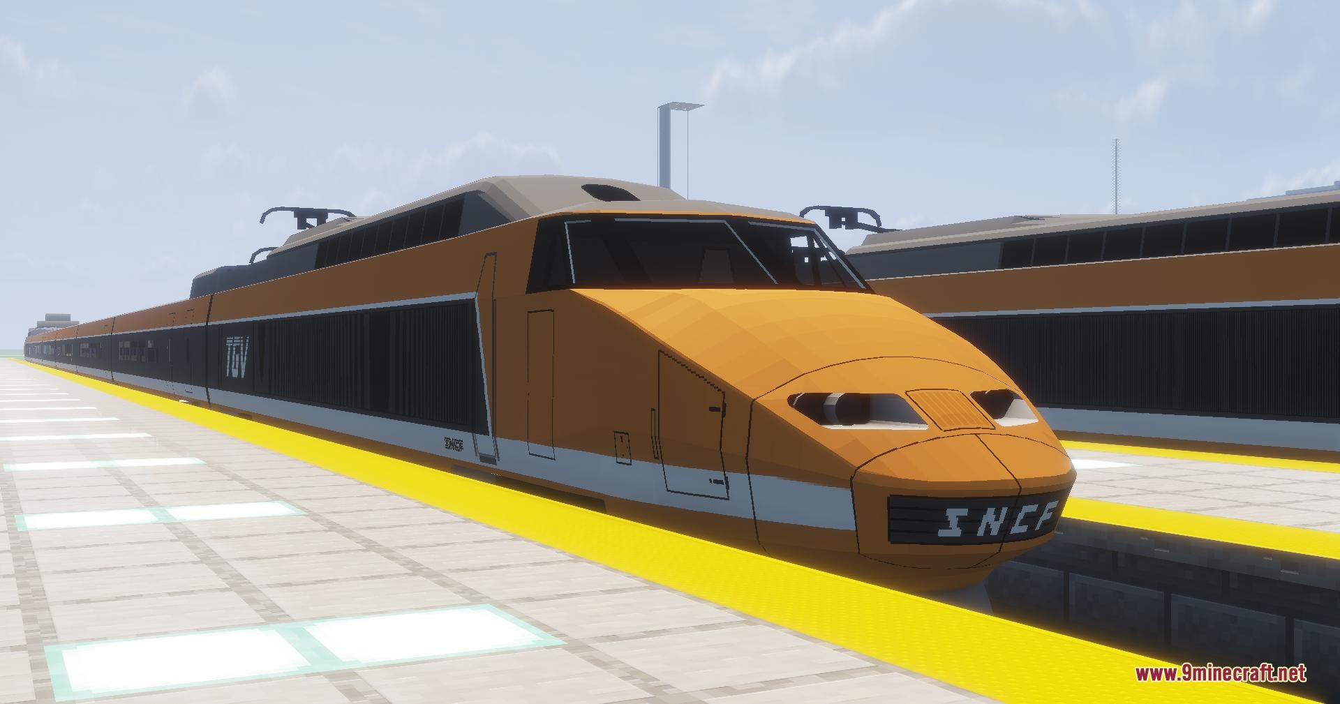 Front view of the classic orange TGV train parked at a platform