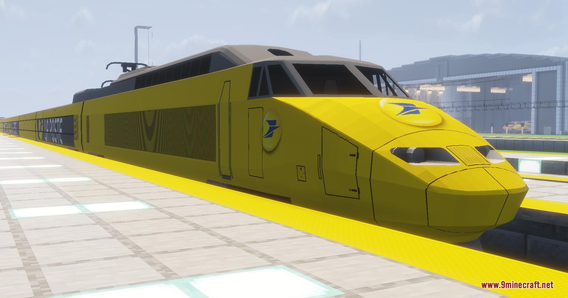 A yellow TGV Postal train parked at a modern railway station platform