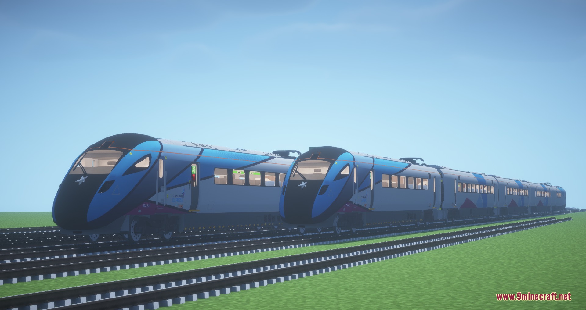 Two identical blue and white passenger trains parked on parallel railway tracks