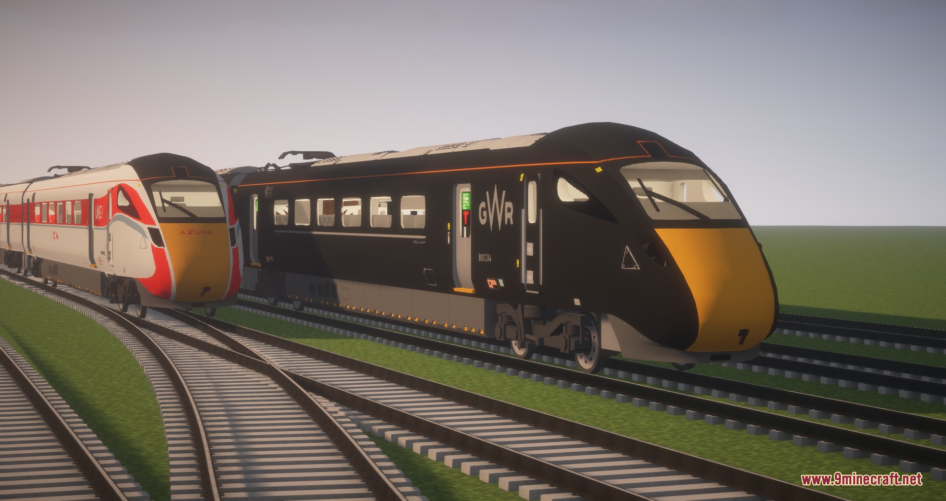 Two modern high speed trains parked on parallel tracks in a field