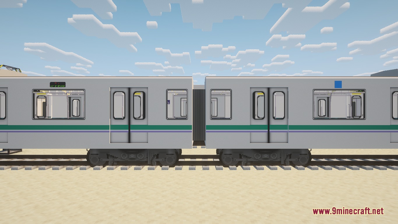Two Tokyo Metro 06 series train cars on tracks in the desert
