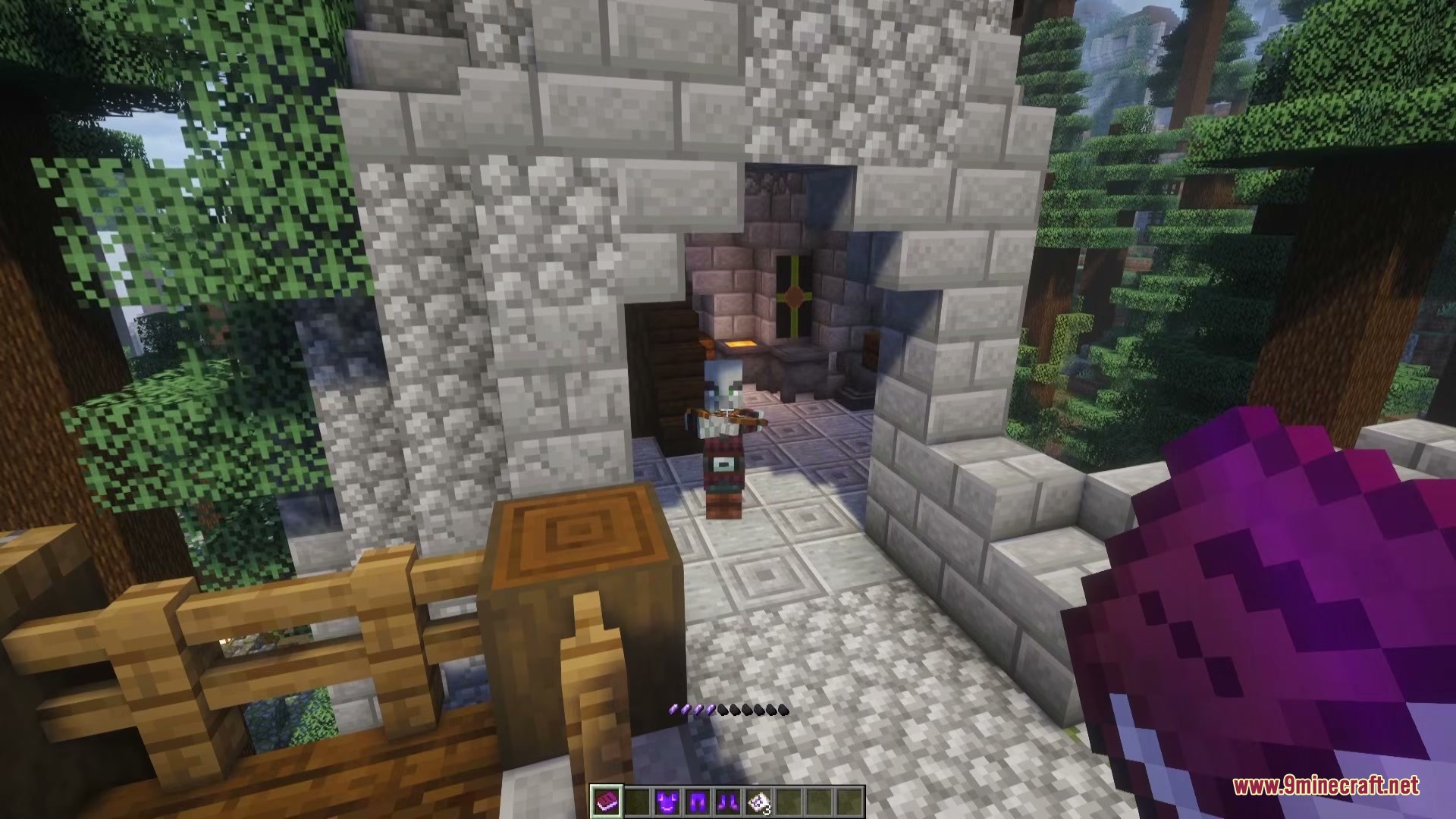 A player holding a purple grimoire confronts a mage inside a stone structure