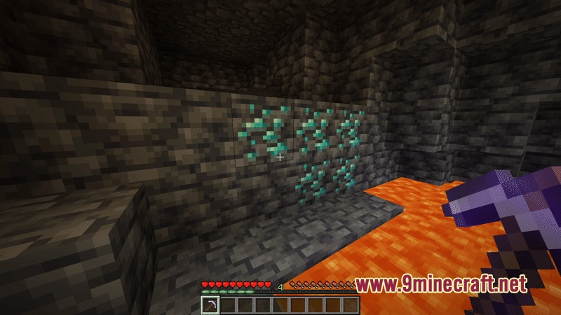 A player mining diamond ore blocks next to a lava pool underground