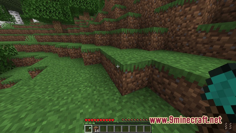 A player holding a diamond shovel while looking at dirt and grass