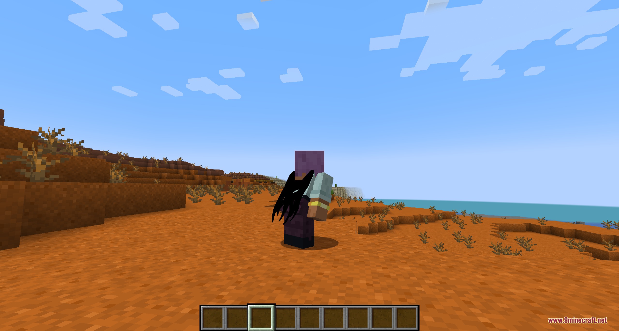 A Minecraft character wearing a black tattered cape in a desert biome