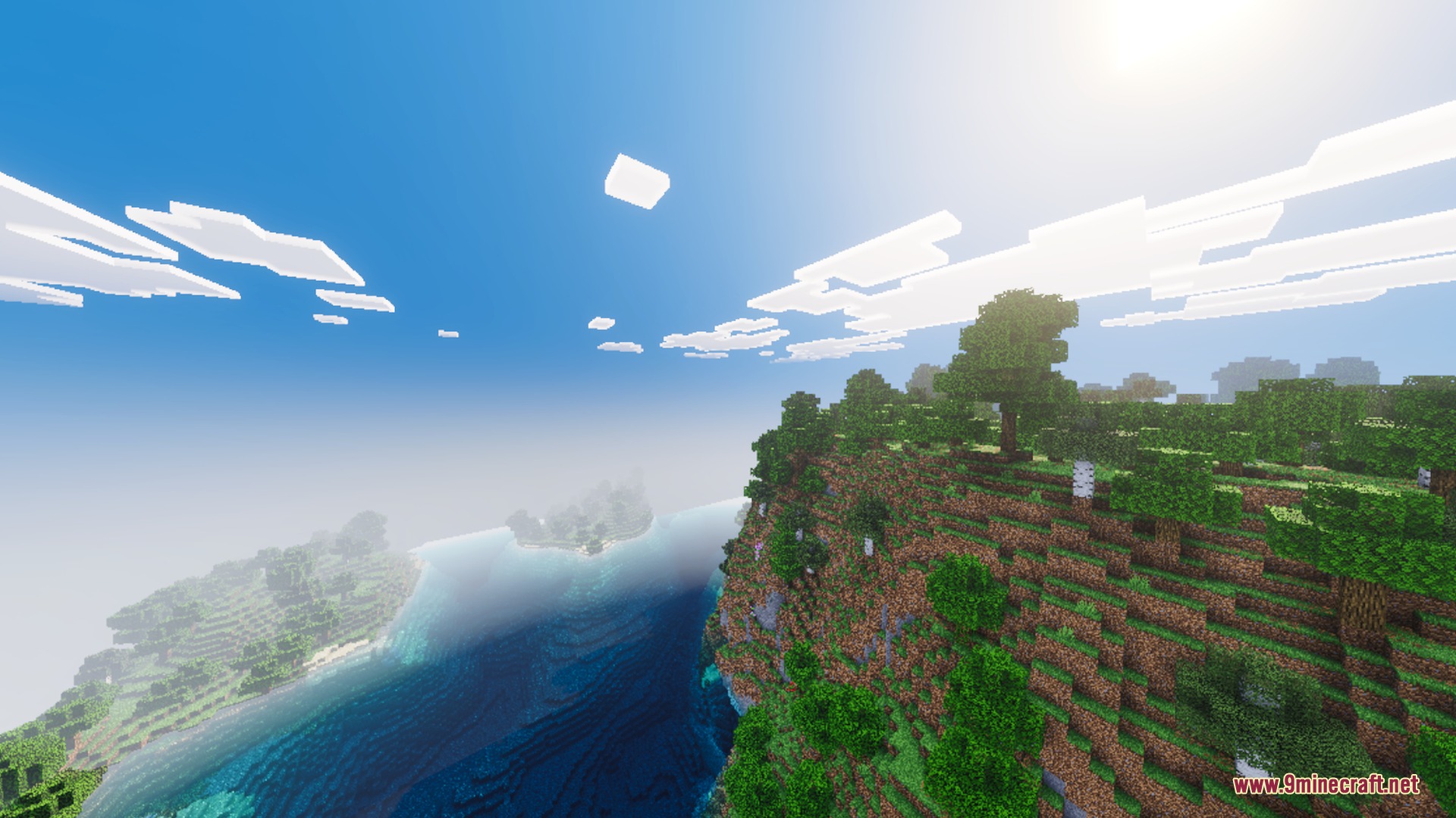 Vibrant blue skies and bright sunlight illuminate a lush green cliffside landscape