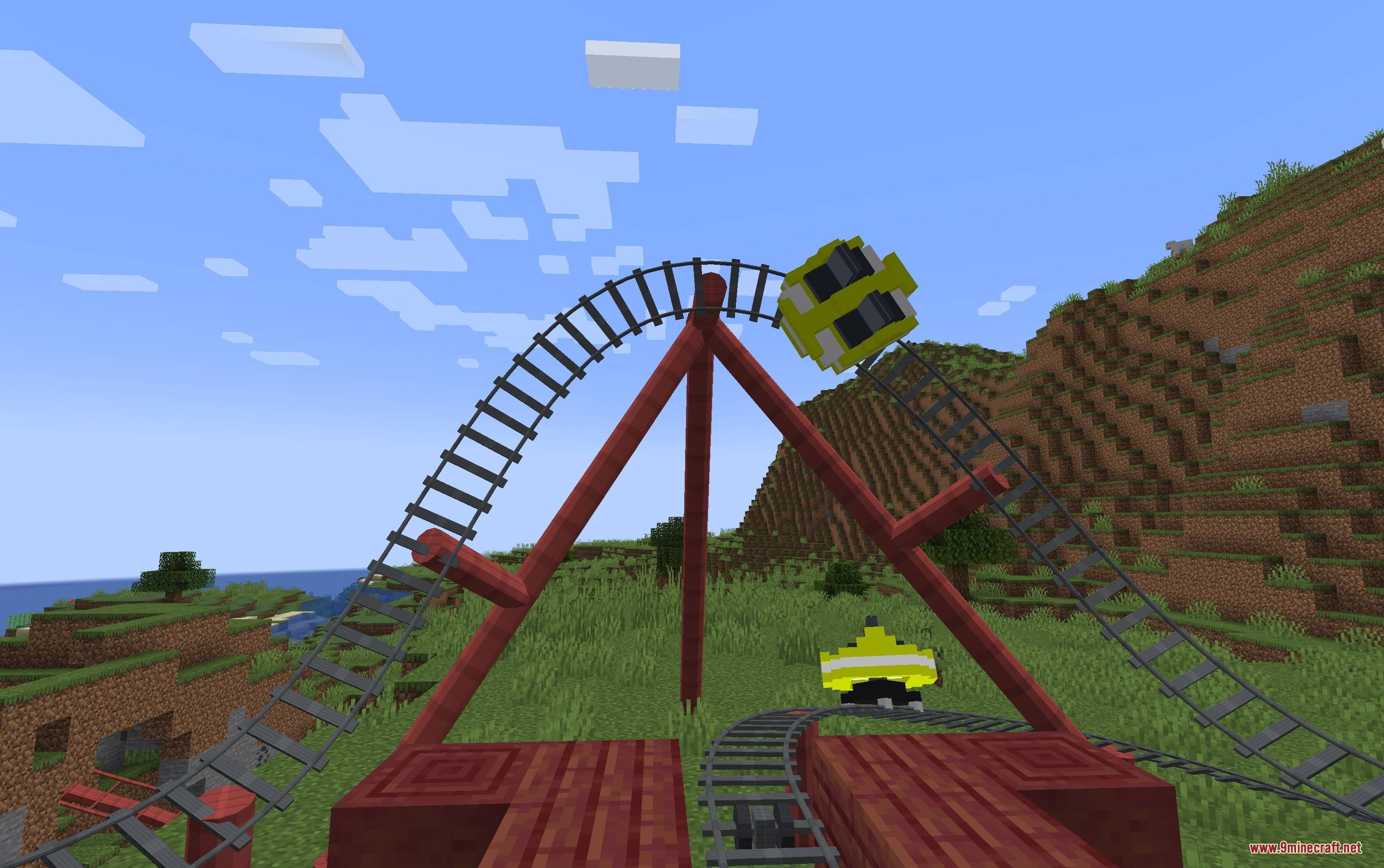 Mine Coasters Mod Screenshot 1 Yellow roller coaster cars moving along red tracks in a grassy Minecraft landscape