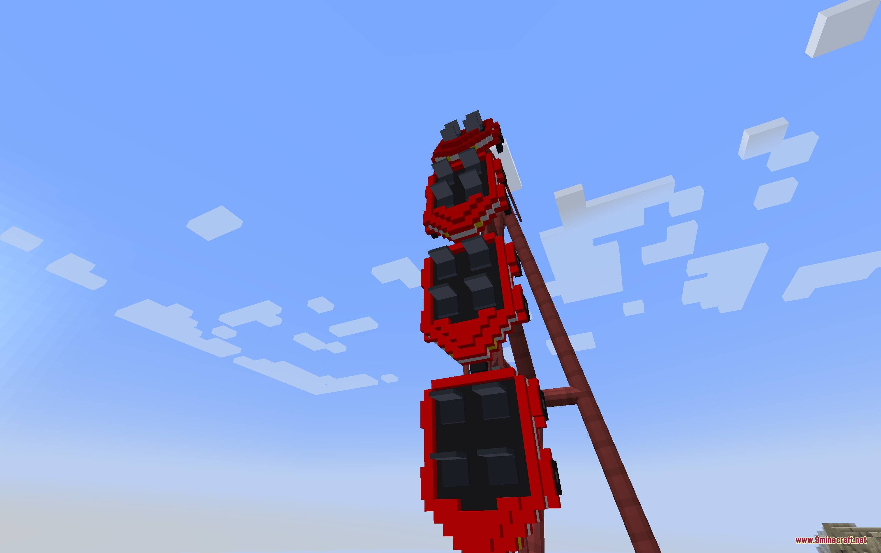 Mine Coasters Mod Screenshot 5 A red roller coaster train climbing a vertical track against a blue sky