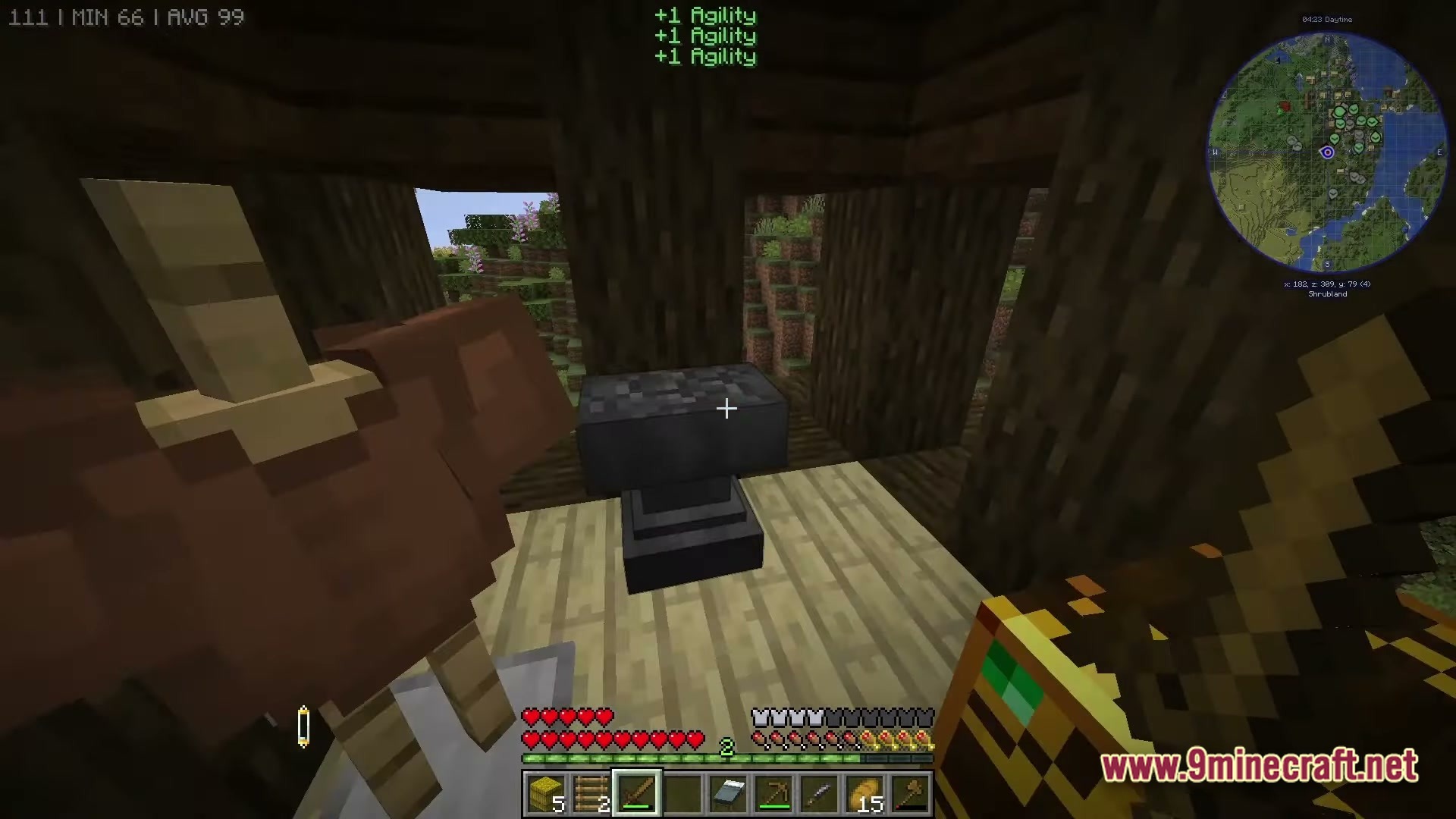Mine Colonies Dimensional Adventure Modpack Screenshot 5 A first-person view of an anvil inside a wooden structure overlooking a shrubland biome