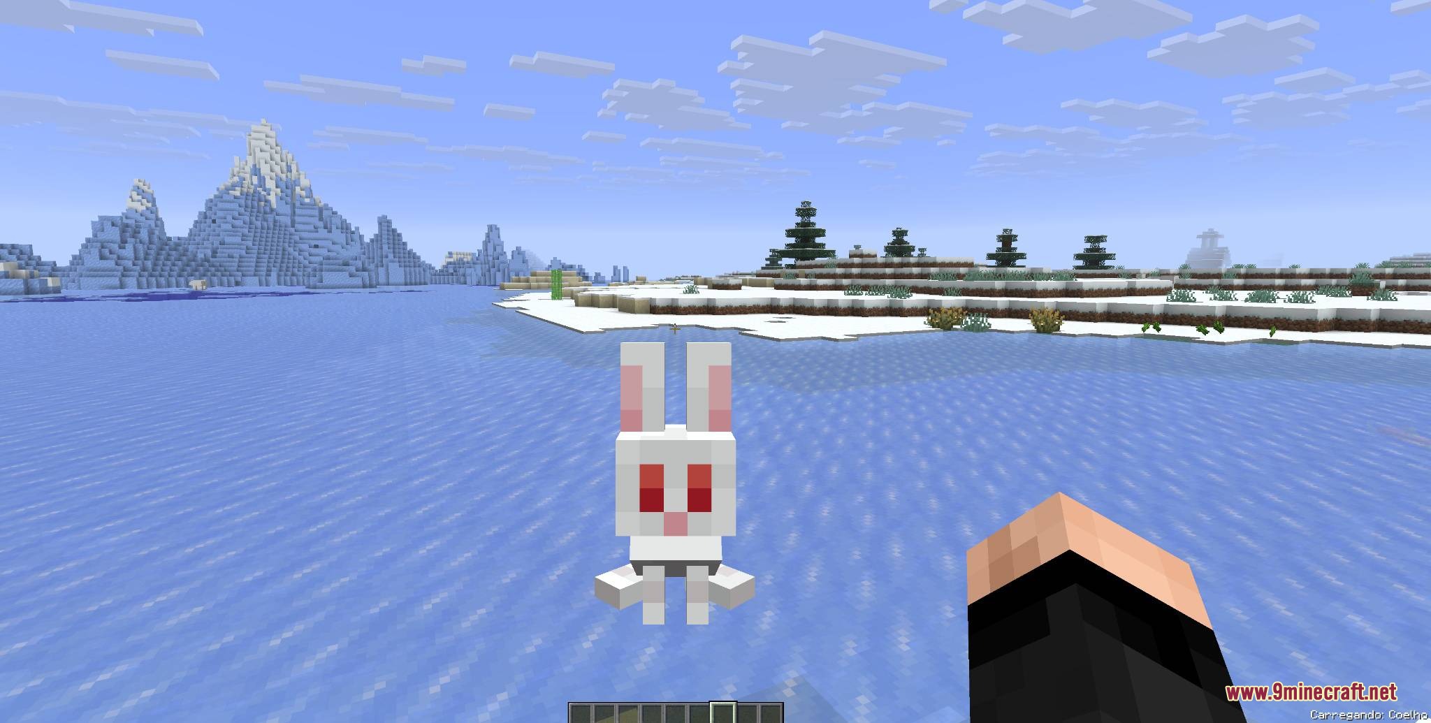 Mobs and Villager Mod Screenshot 5 A player holding a white rabbit in their hand over a frozen ocean
