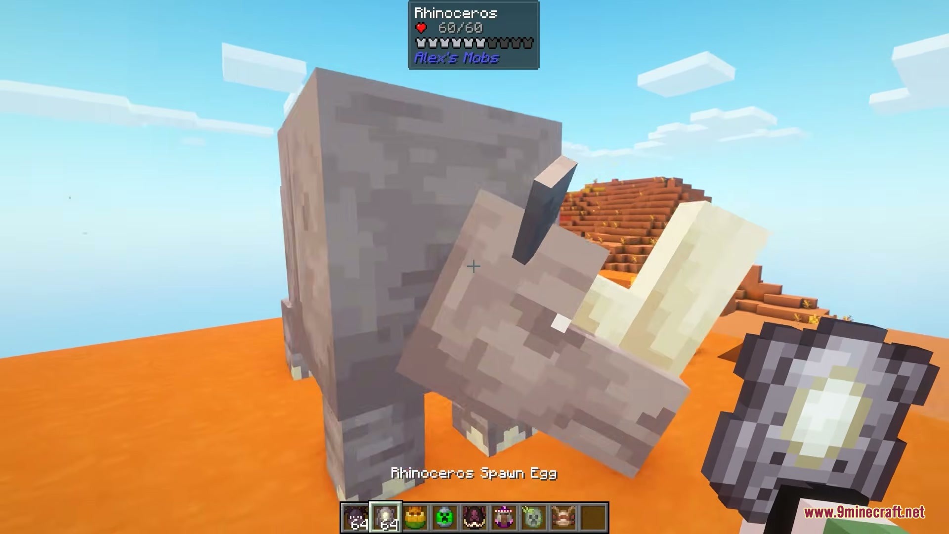Modded Omelet Modern Spawn Eggs Resource Pack Screenshot 2 A player displays a custom Rhinoceros spawn egg in a desert biome