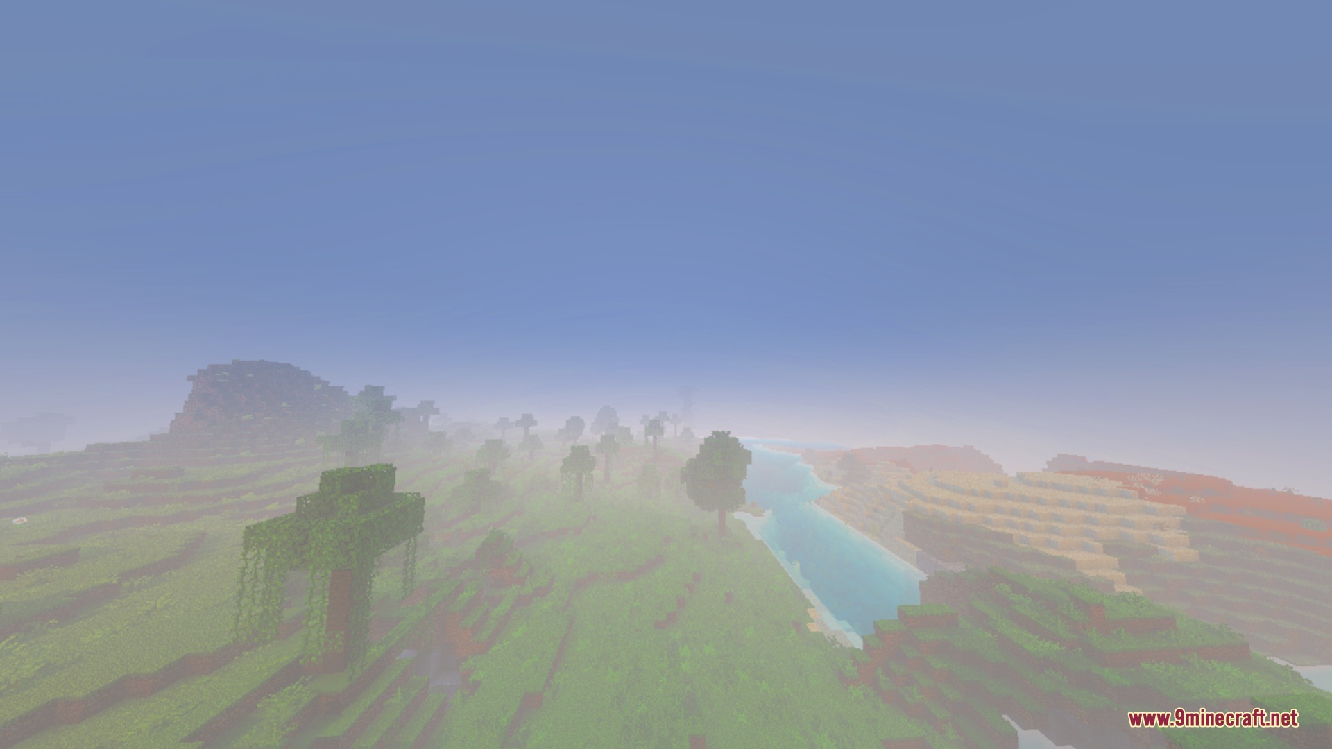 Soft dreamy fog covers the rolling green hills and distant river landscape