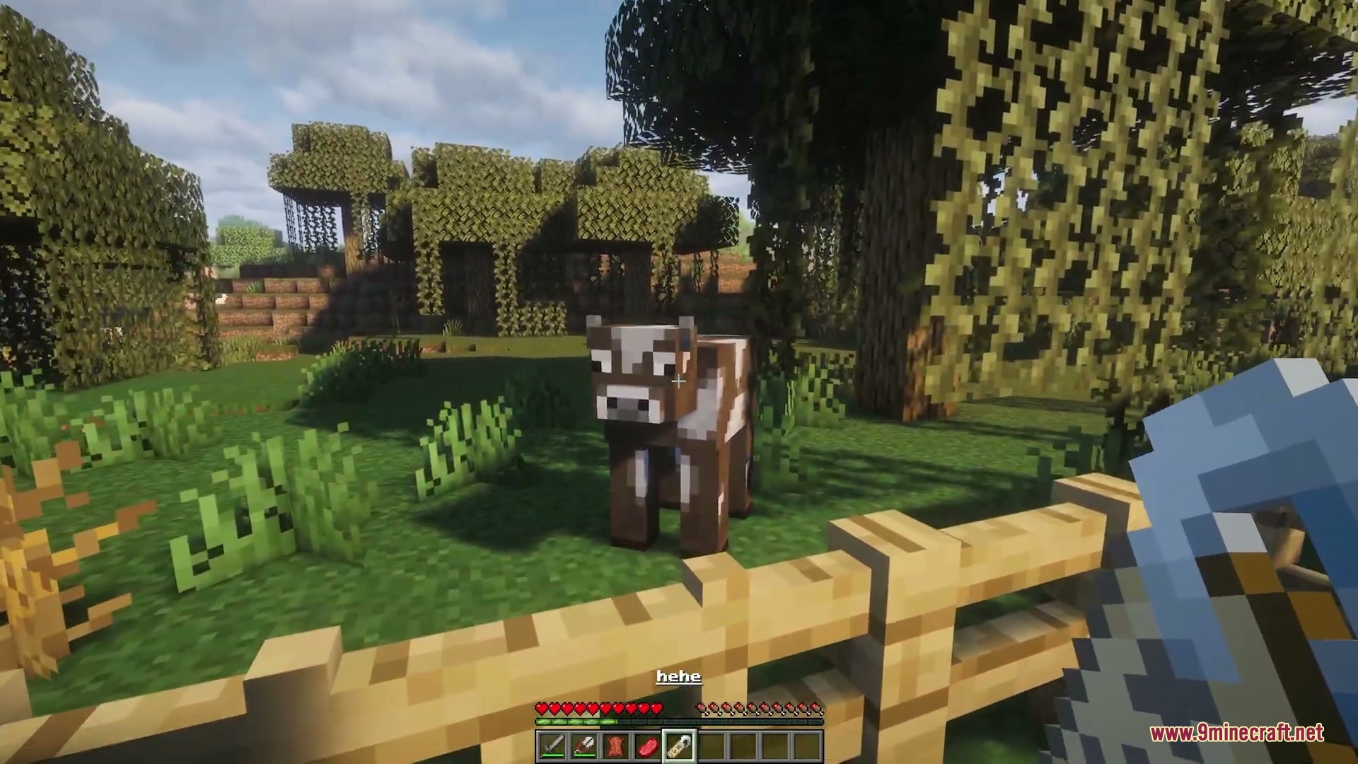 Name Tag Upgrade Mod Screenshot 6 Player holding a name tag to rename a cow in a fenced area
