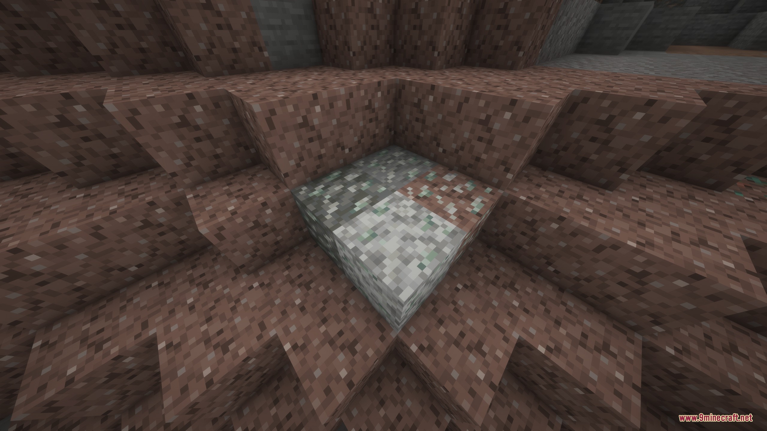 Ore blocks blending into surrounding granite and diorite stone in a cave