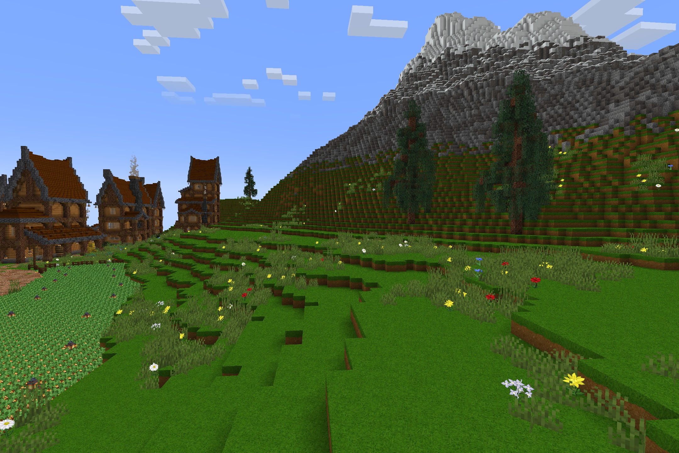 Lush green hills with flowers leading towards a large mountain and stylized trees