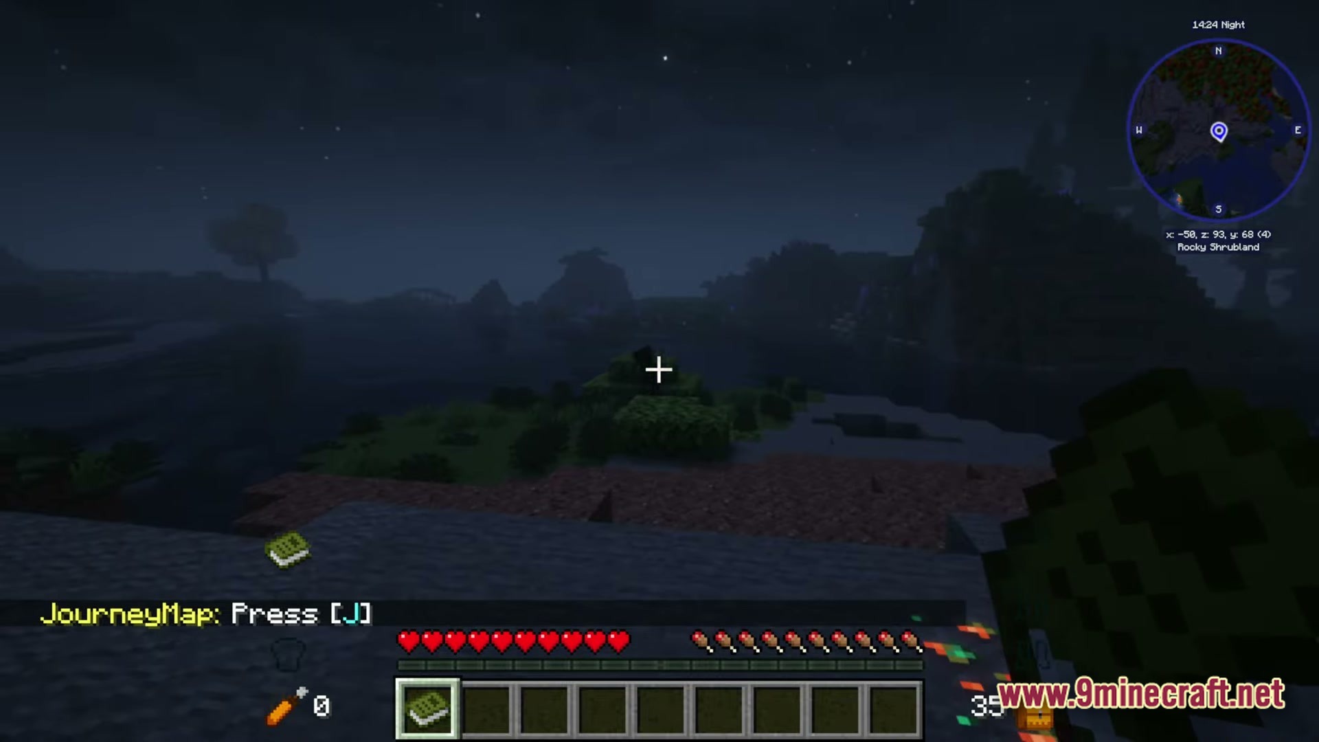 A first-person view of a rocky shrubland biome at night featuring a JourneyMap interface and minimap