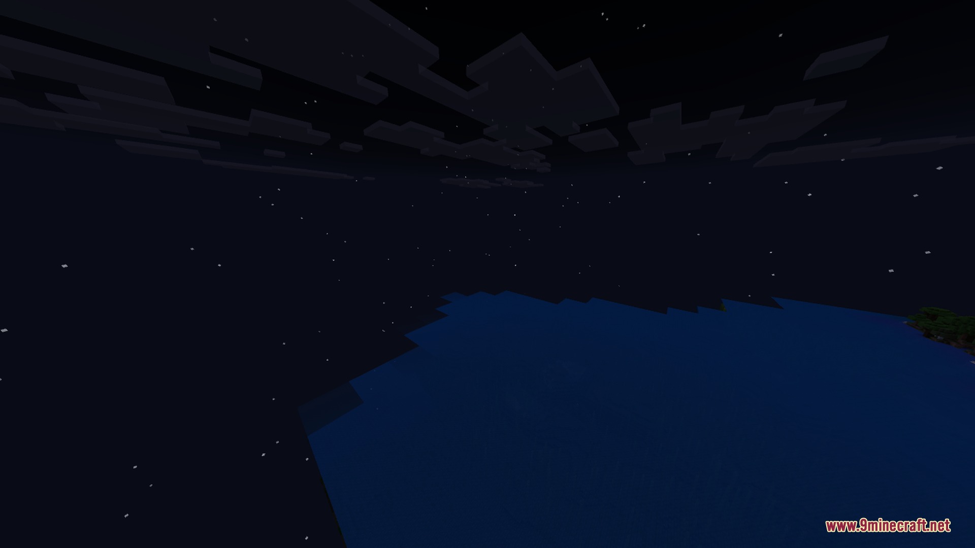 Night sky with stars and blocky clouds above a dark blue ocean
