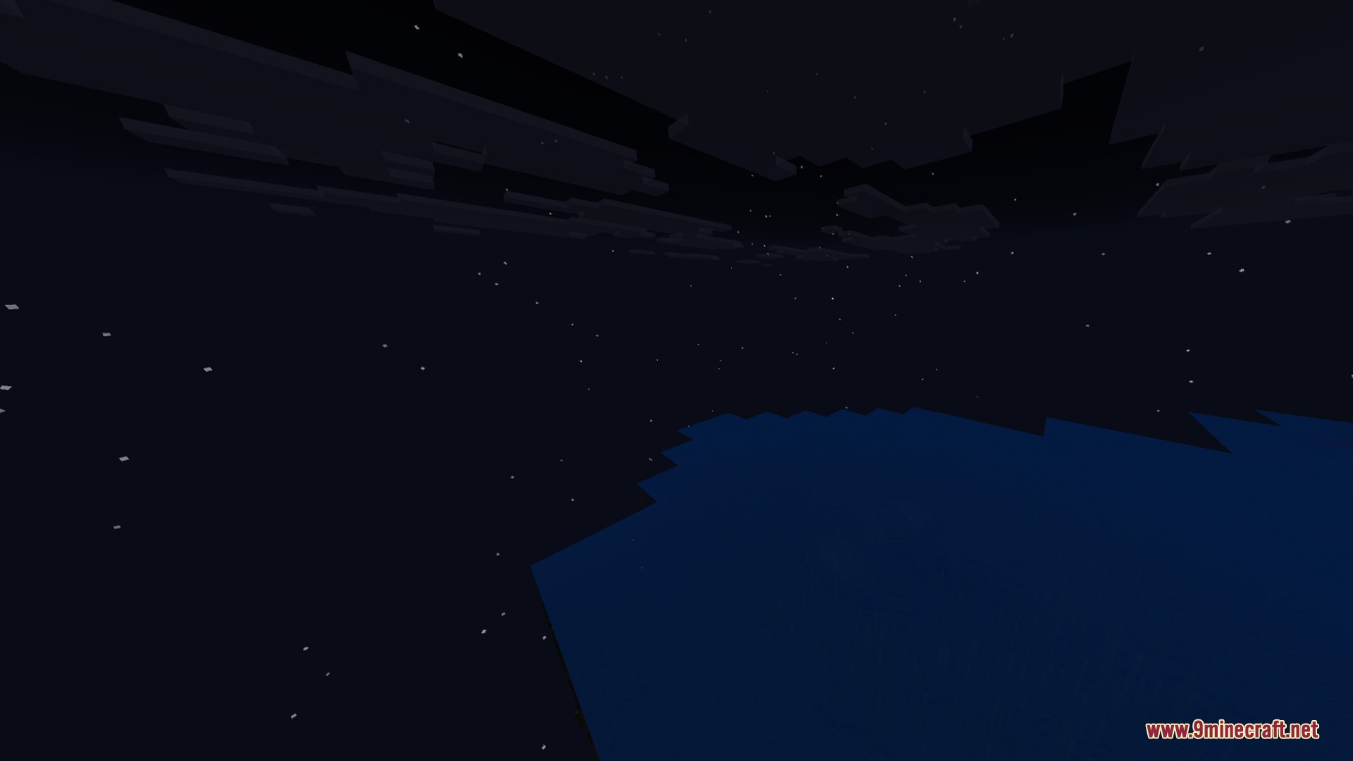 Dark night sky with stars and blocky clouds over the ocean