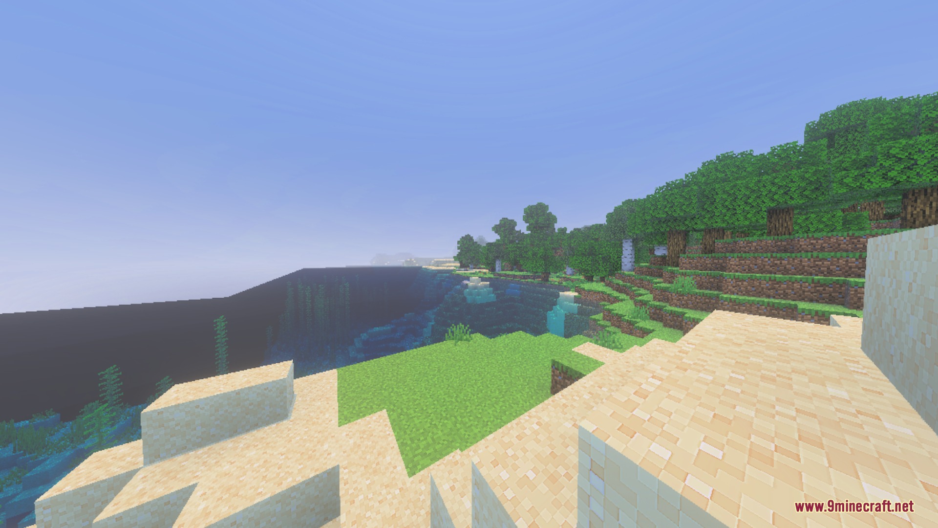 A scenic Minecraft beach view with lush green grass and clear water