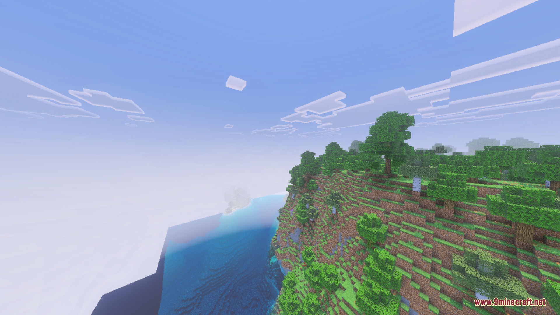 Lush green trees on a cliffside overlooking the saturated blue ocean water