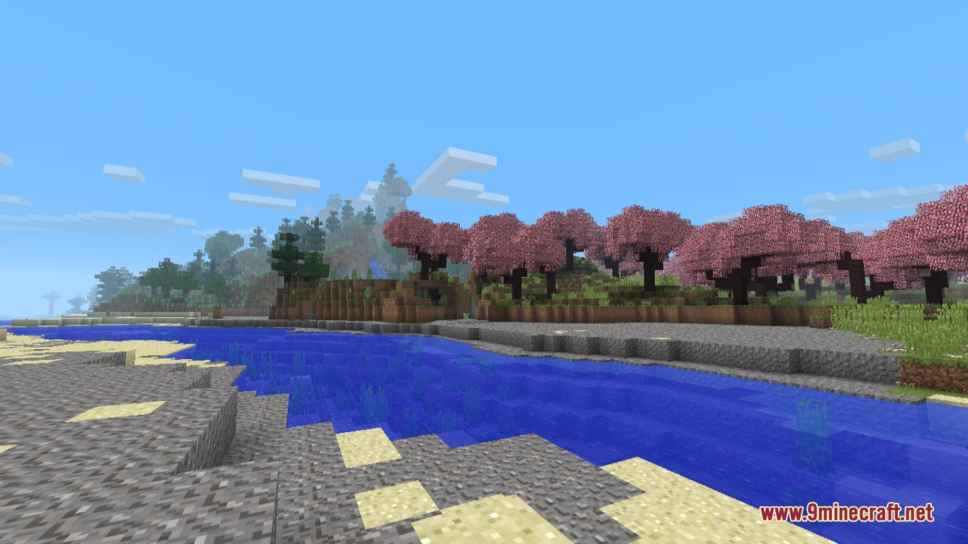 A scenic river flowing past a forest of pink cherry blossom trees