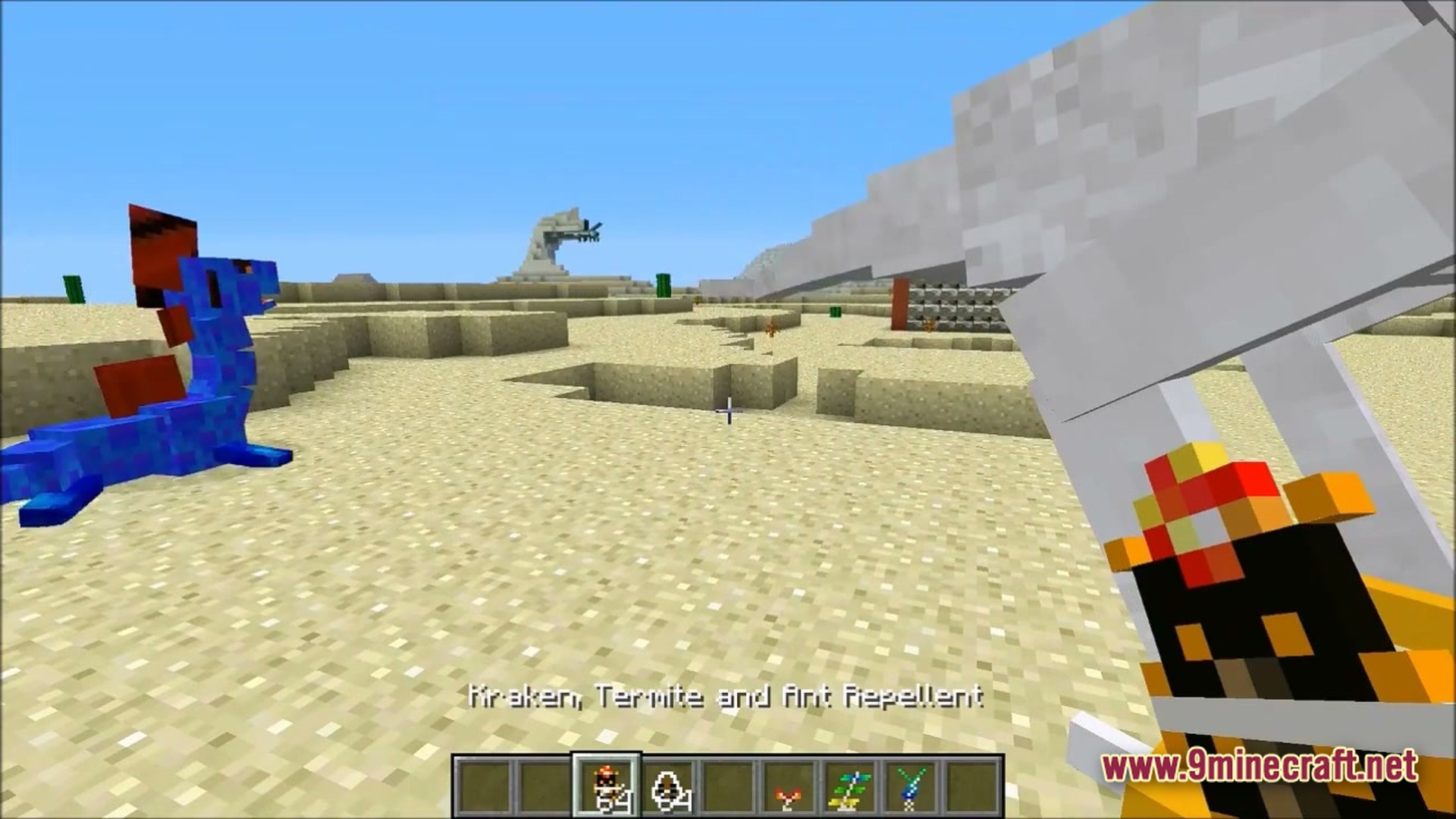 Ore Spawn Adventuree Modpack Screenshot 5 A player holds a repellent item while facing a blue dragon mob in a desert biome