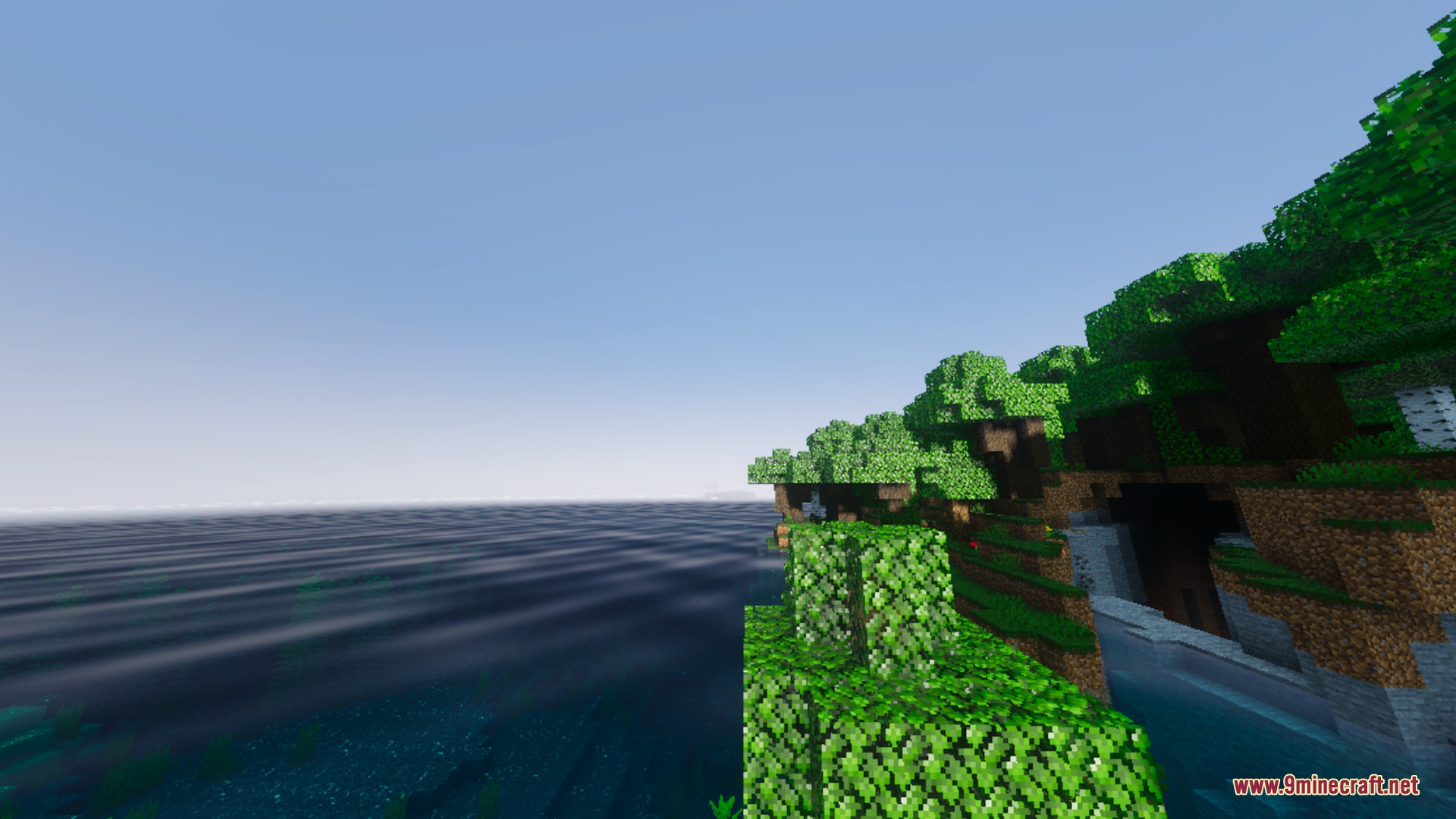 Origin Vibrant Visuals Shader Screenshot 2 Lush green trees on a cliff overlooking the calm and clear ocean water
