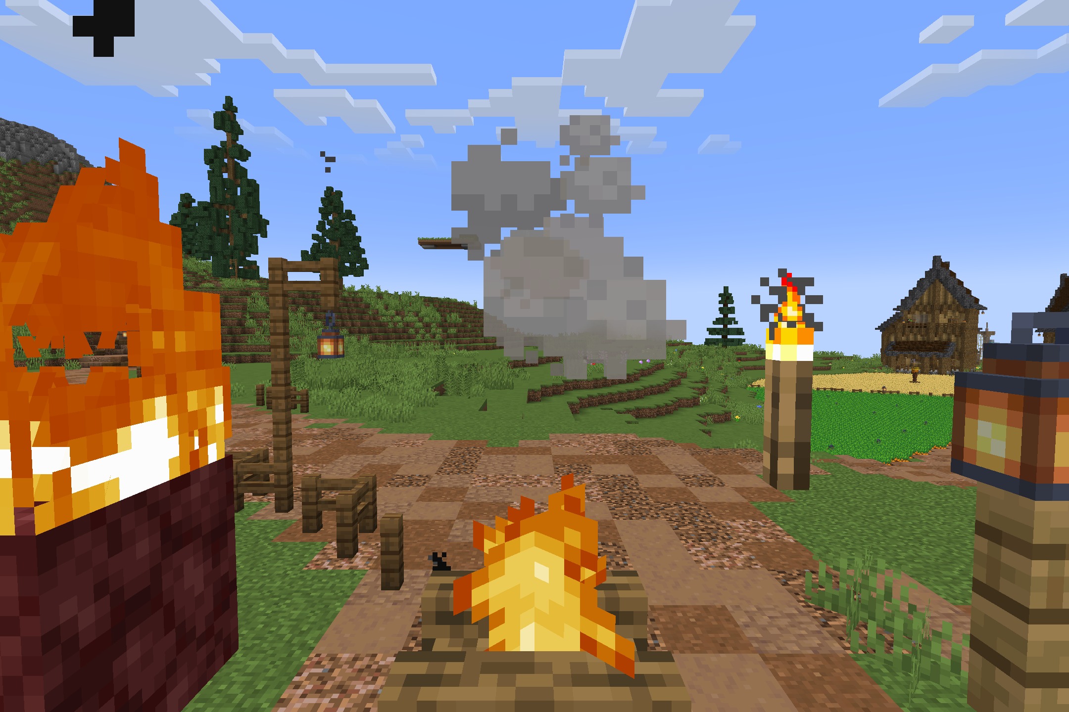 A dirt path decorated with campfires and torches leading to a wooden house
