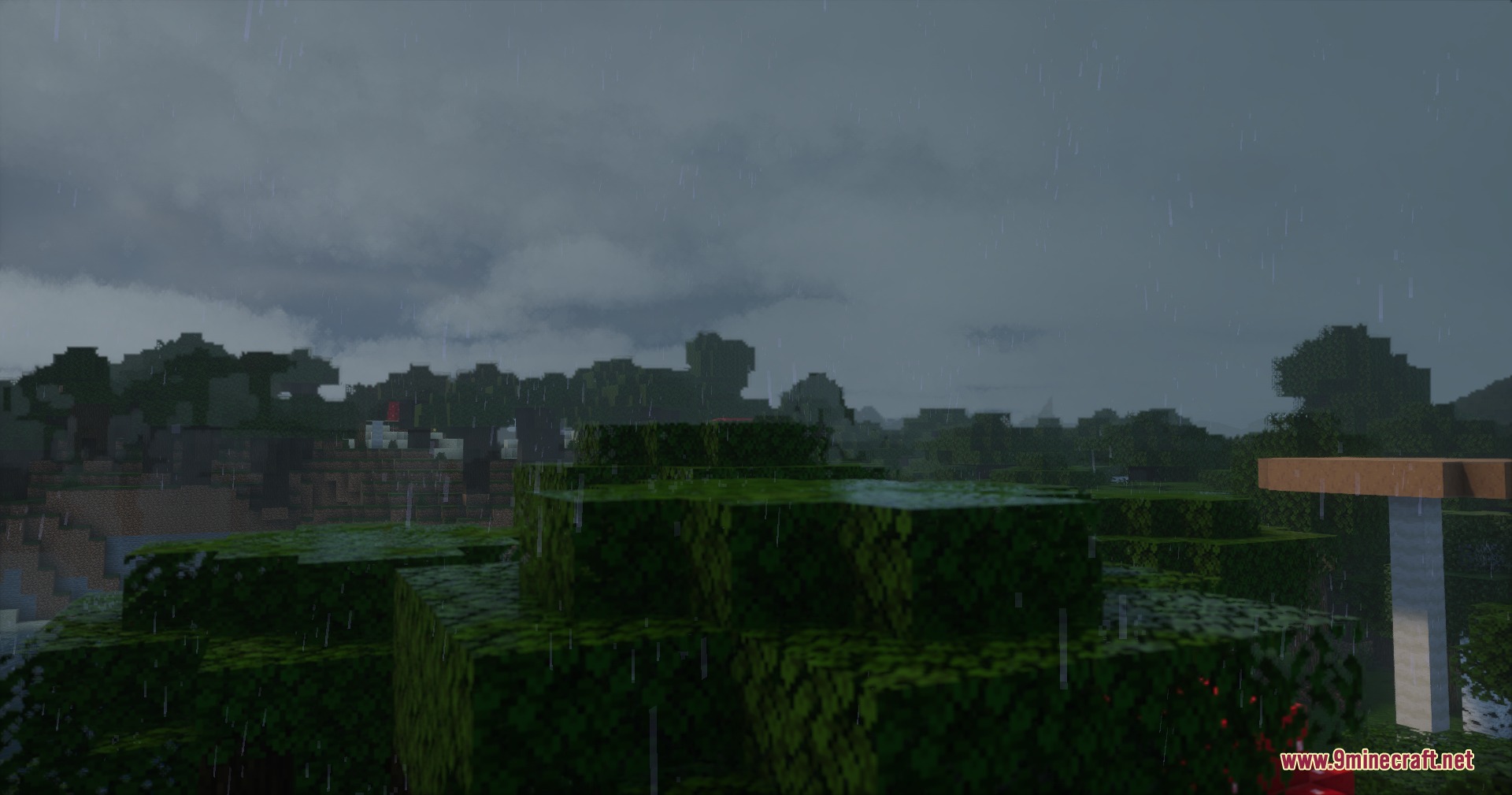 PMW Precipitation Redone Resource Pack Screenshot 5 Rain falling over a lush green landscape under a dark and cloudy sky
