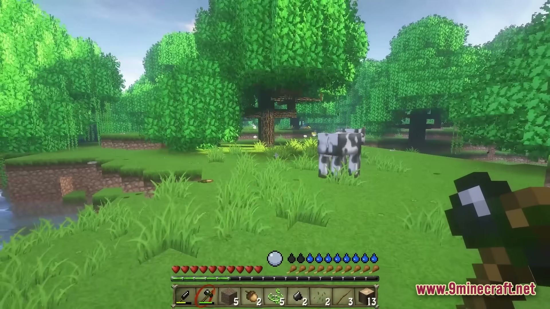 A player holds a stone axe near a cow in a lush forest with stylized graphics