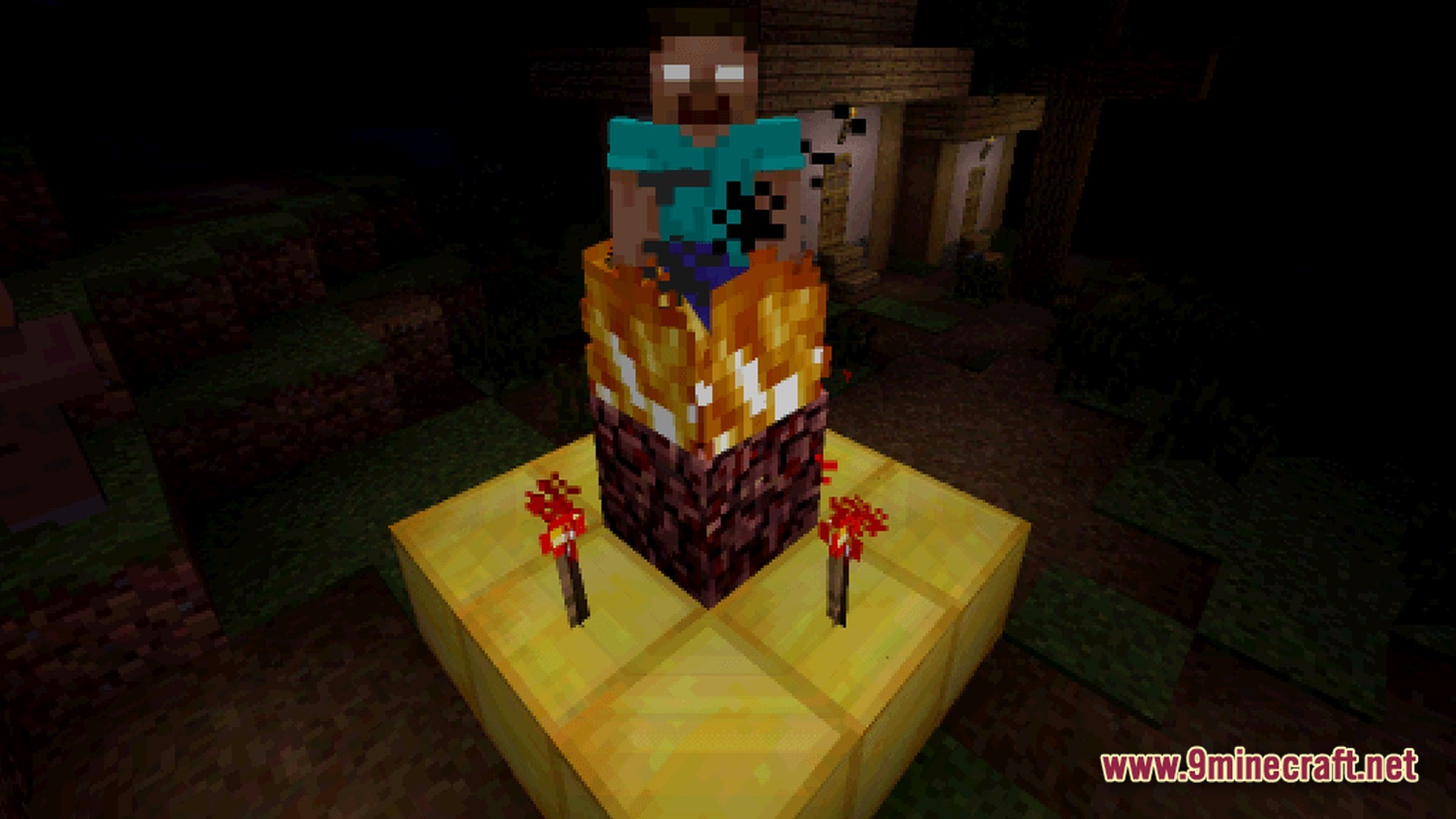 Herobrine stands atop a burning netherrack and gold block shrine at night near a village