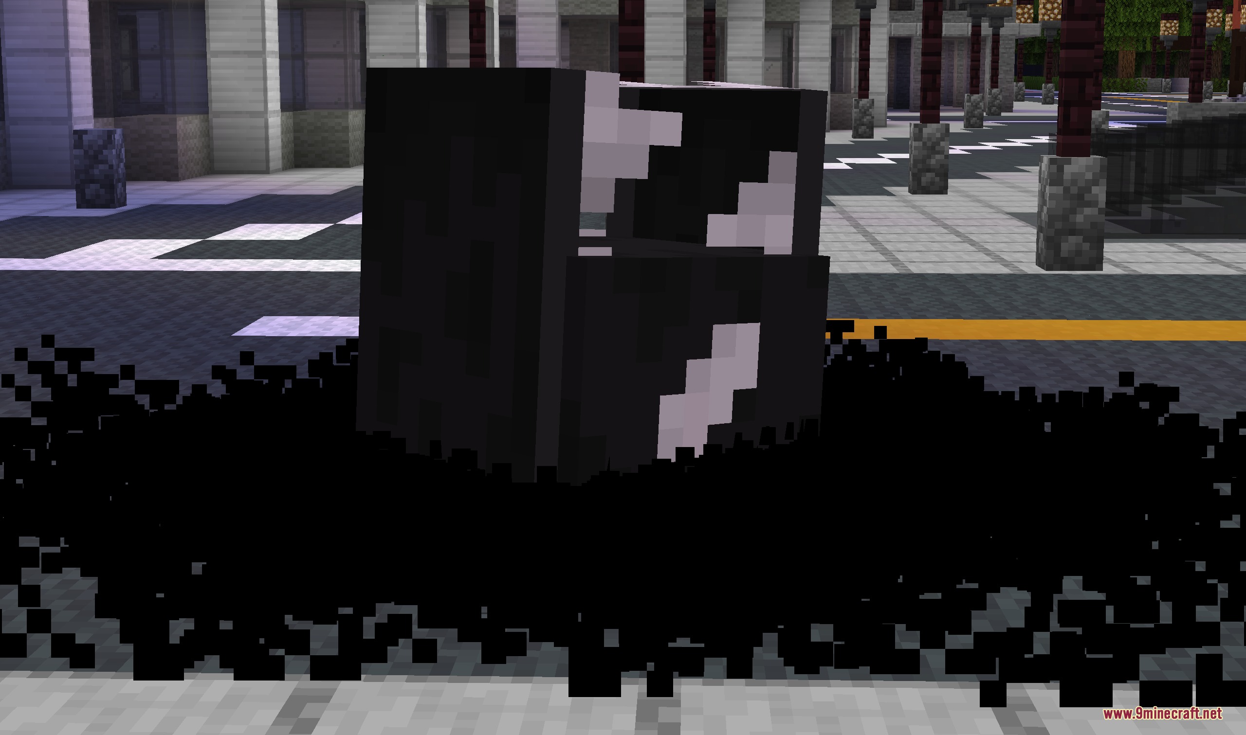 A black symbiote mass burrows into the ground on a city street