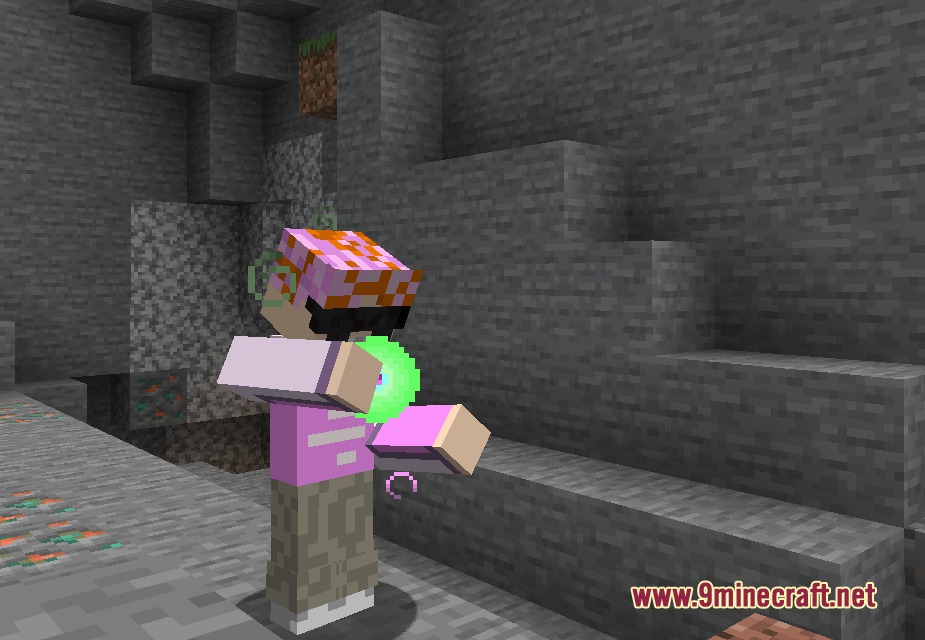 A player character holding a glowing green energy orb inside a stone cave