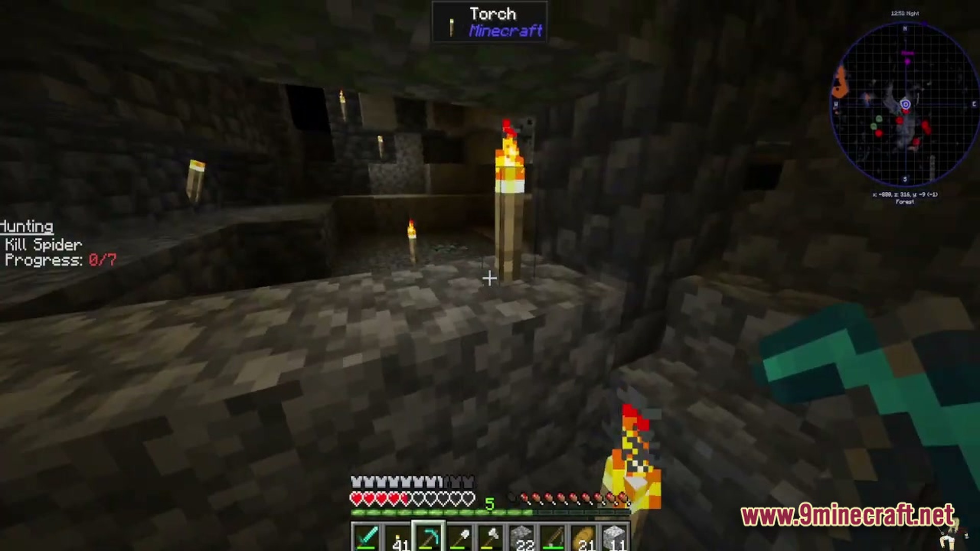 Petalwood Whispers Modpack Screenshot 6 A player explores a dark cobblestone cave lit by torches while holding a diamond pickaxe