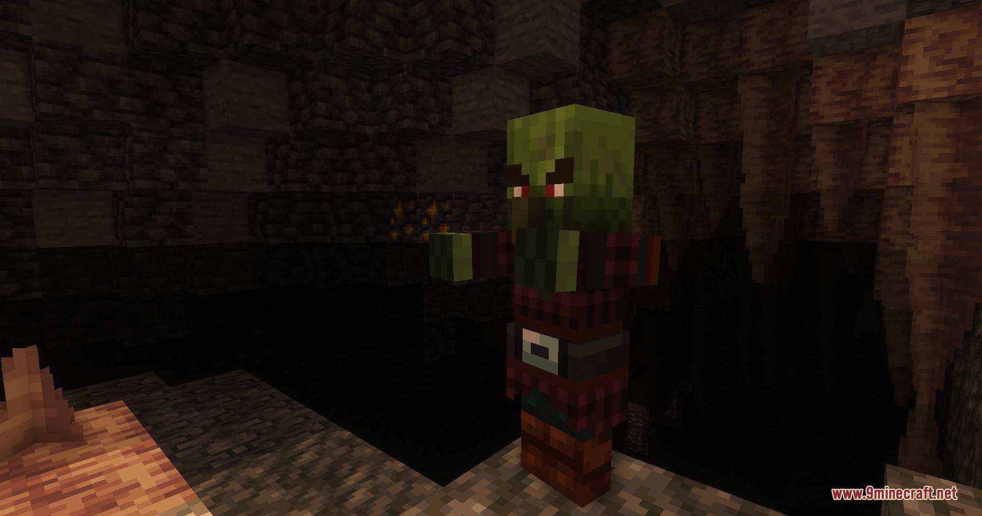 Pillagers Plus Mod Screenshot 4 A green miner pillager stands near stalactites in a dark underground cave