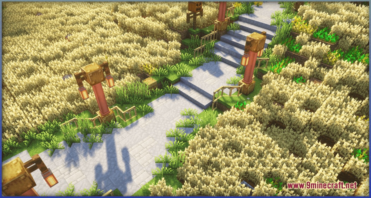 A stone path with lanterns winding through a field of golden wheat