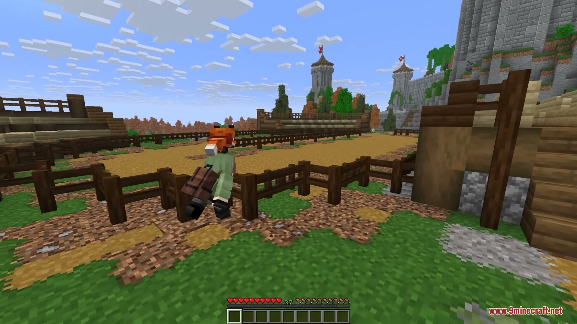 Player Charge Jump Mod Screenshot 1 A player character with a fox head explores a medieval village with fences