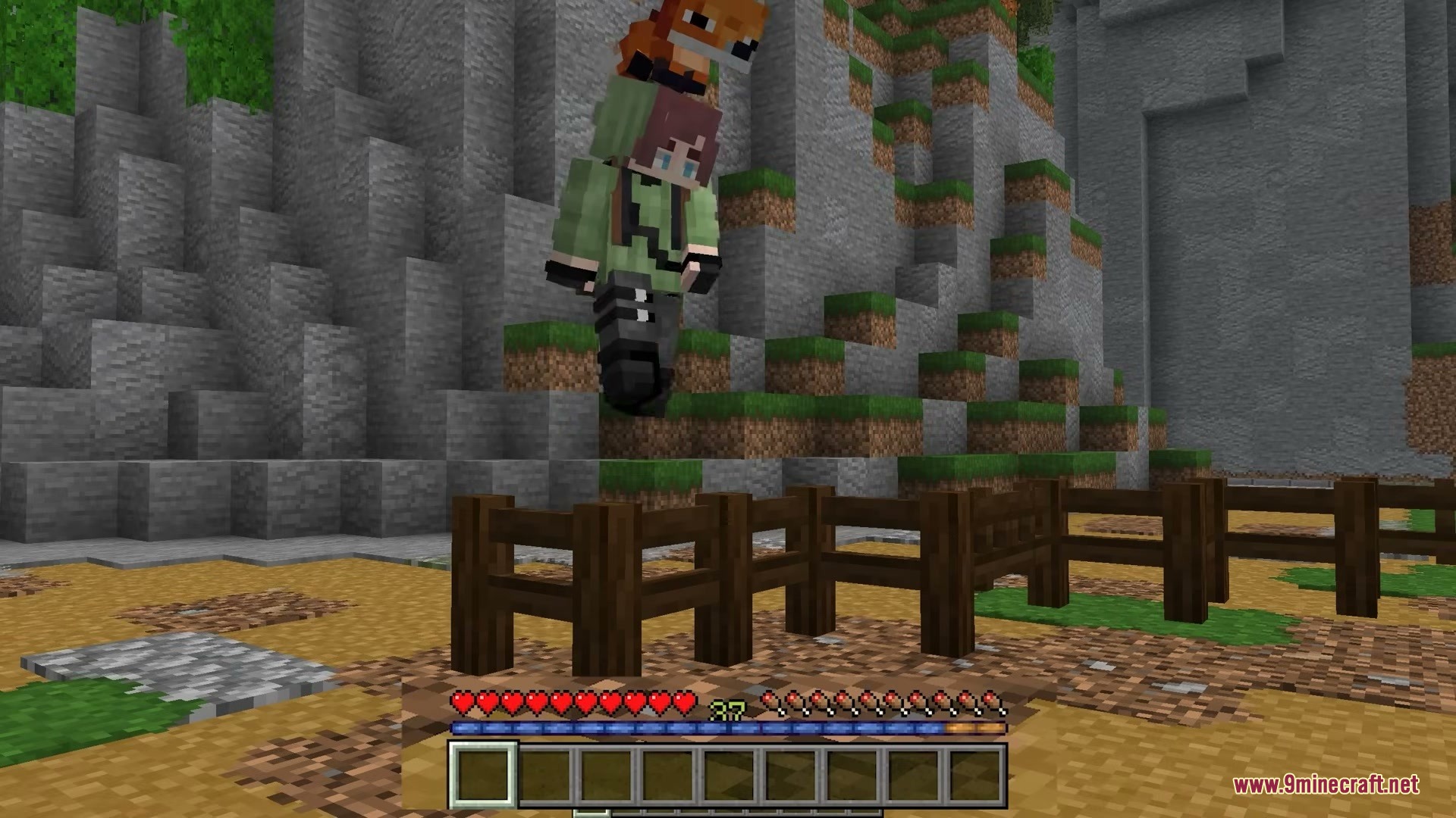Player Charge Jump Mod Screenshot 2 A player character leaps over a wooden fence using a charged jump bar