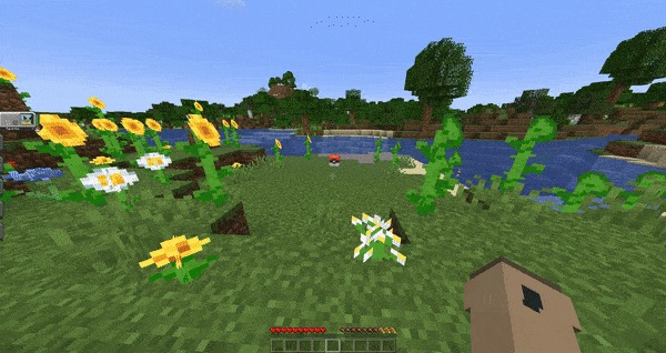 A lone Poke Ball capsule sits in a field of yellow sunflowers