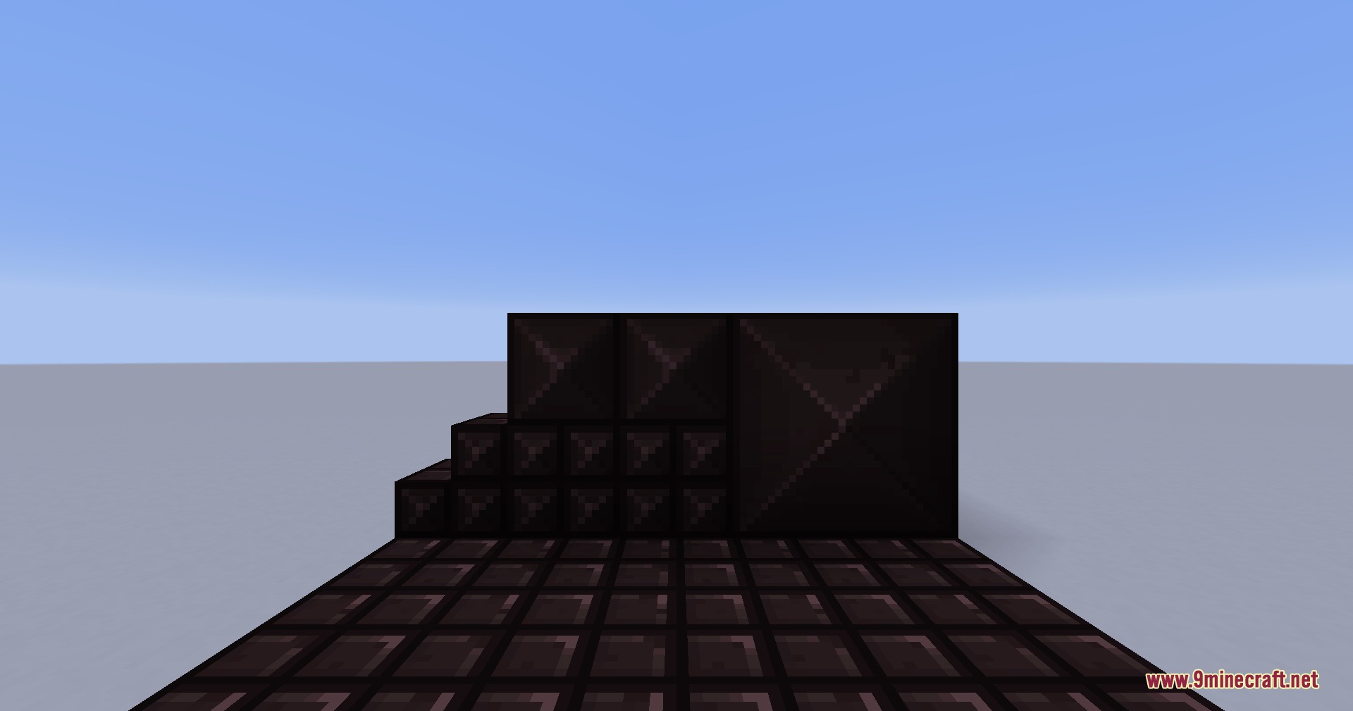 Dark blackplate blocks arranged in a staircase pattern on a tiled floor