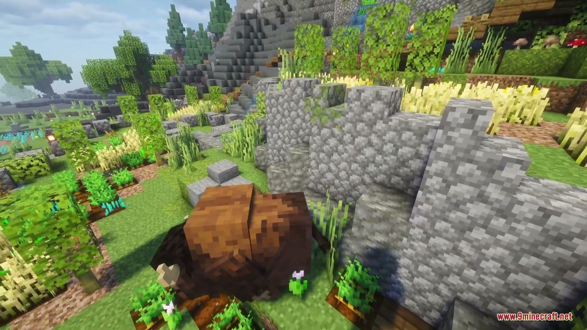 Prairie Meadow Behemoths Mod Screenshot 4 A bison resting peacefully on the grass near a small farm area