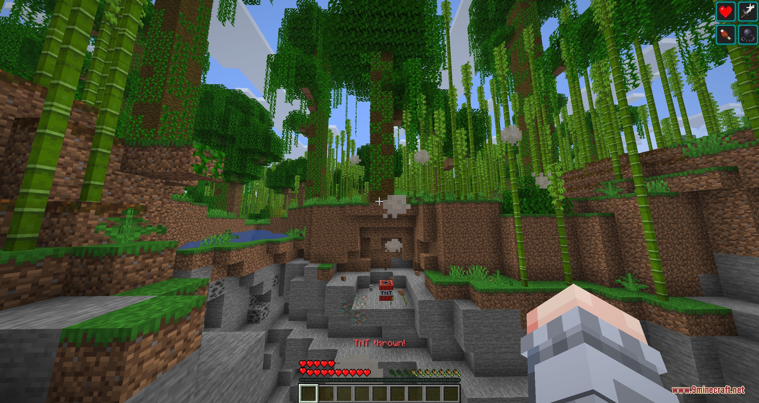 Minecraft player throwing ignited TNT in a dense bamboo forest biome