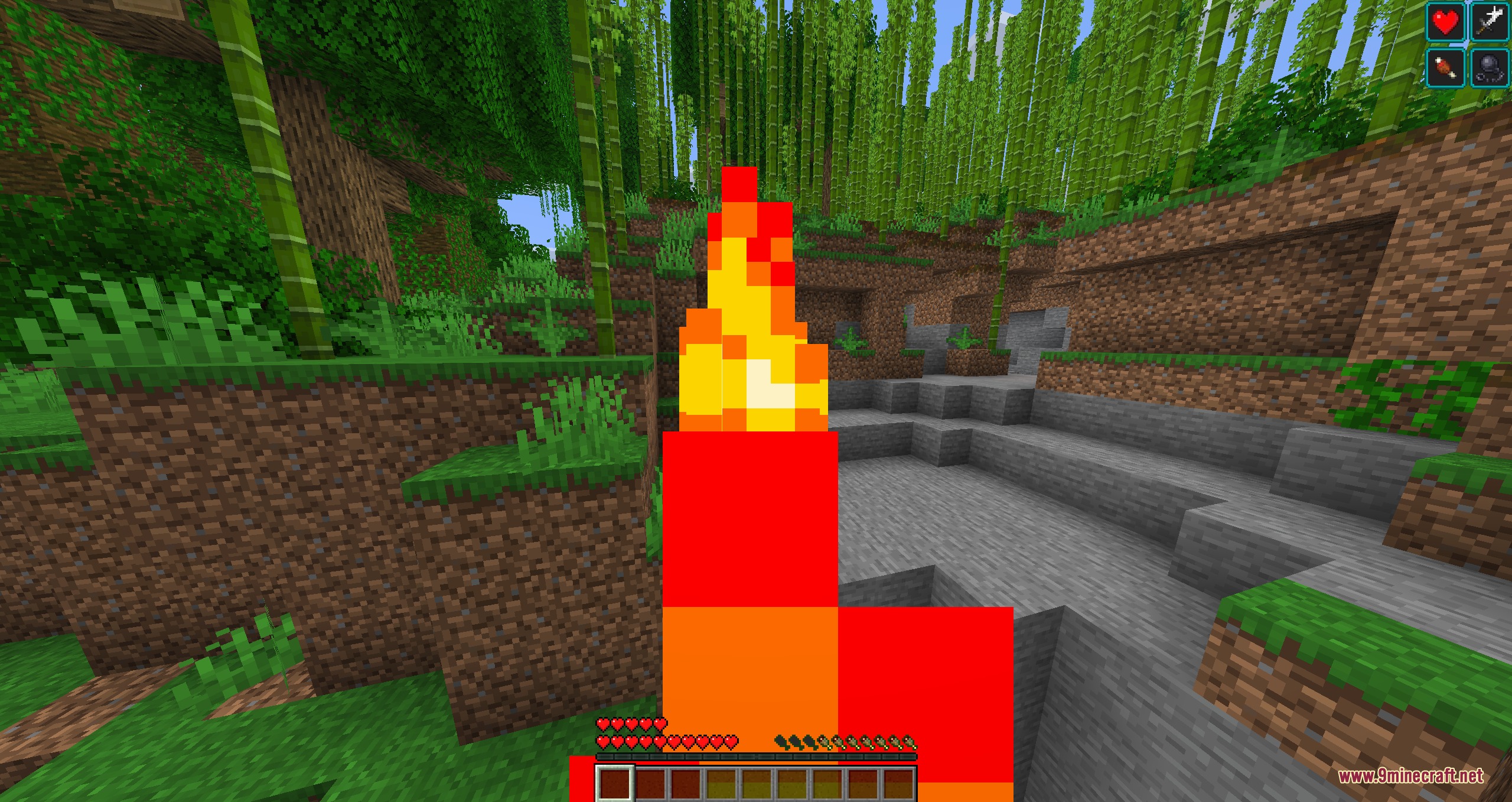 The player character is burning with fire effects in a jungle environment
