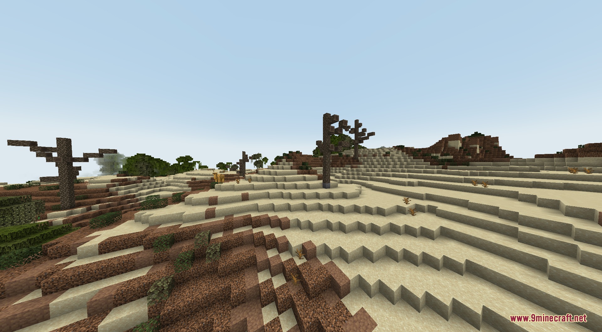 Arid desert landscape with layered sand blocks and custom dead tree variations