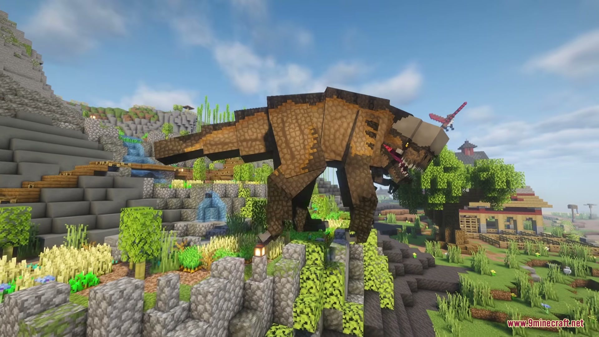 A massive brown Tyrannosaurus rex stands on a rocky cliff in the wild