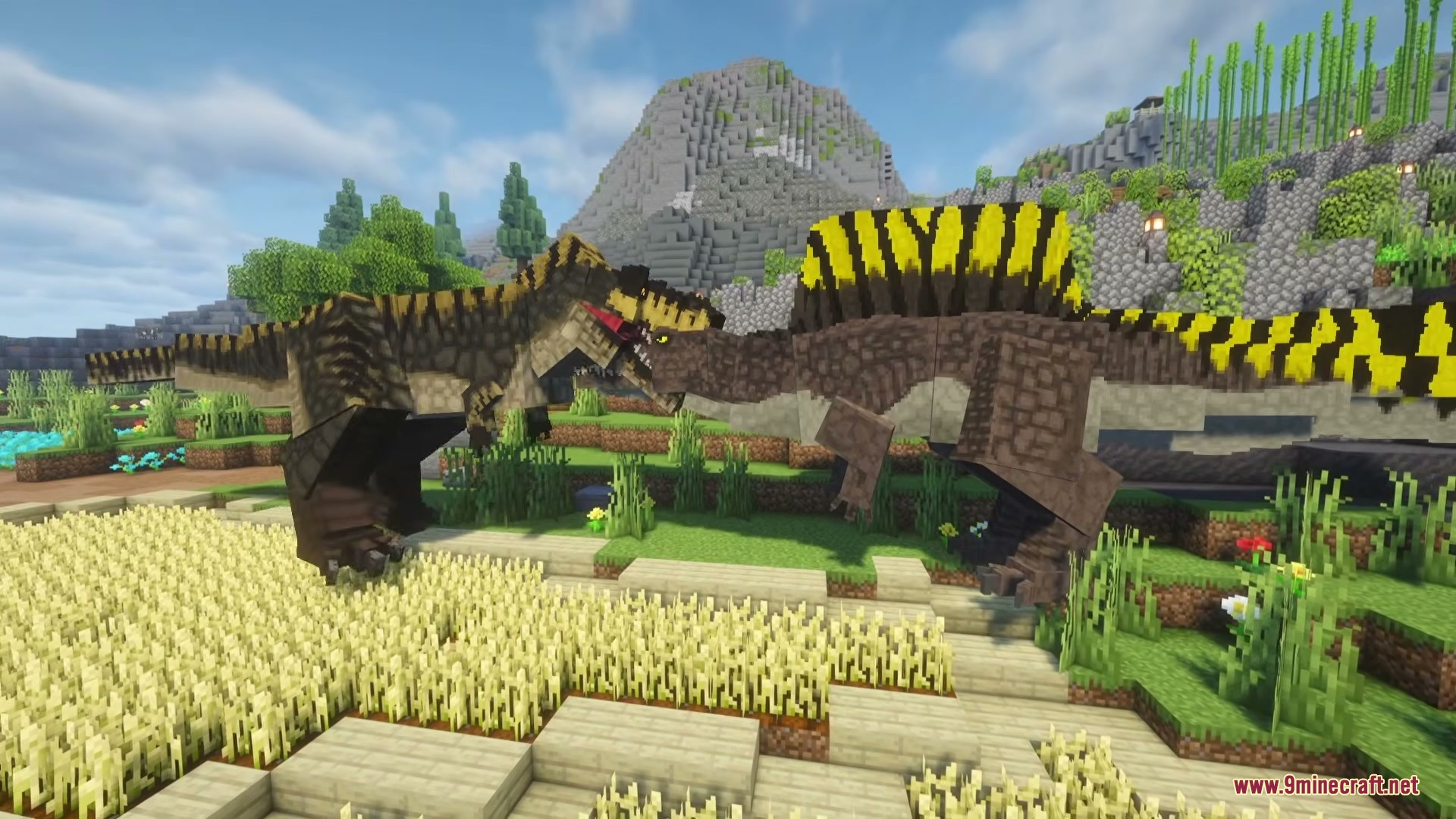 Two massive dinosaurs facing each other in a grassy field near mountains