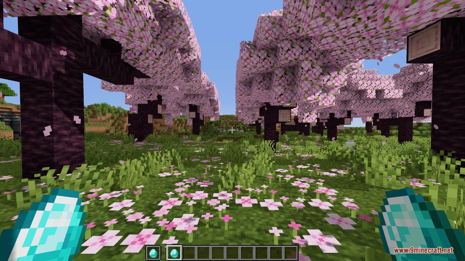 PvP Smaller Hand Helds Resource Pack Screenshot 3 Player holding two small diamonds while standing in a cherry blossom grove